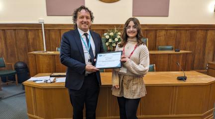 New member of youth parliament Honey Barker receives a certificate from director of children's services, Milorad Vasic