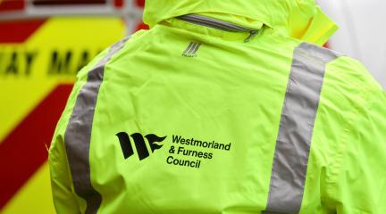 Back of a highways officer in Westmorland and Furness hi-vis