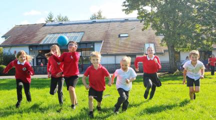 Children running in school field