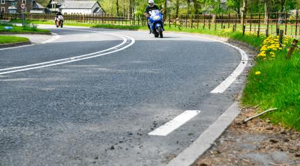 Motorbike riding round a bend in Patterdale