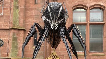 A bee sculpture made out of guns and knives on display outside Barrow Town Hall.