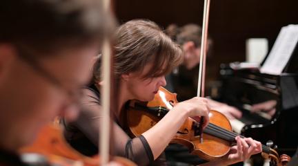 young people playing violins