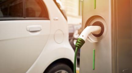 An electric car plugged into a charging point