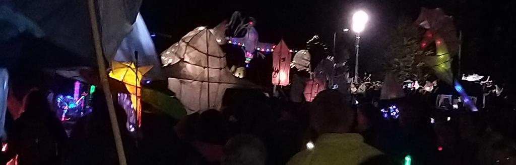 People in a procession at night holding lanterns