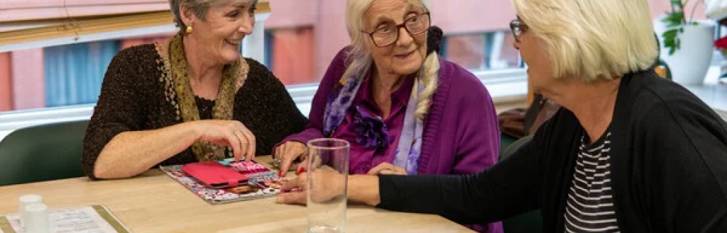 Three carers talking at a table