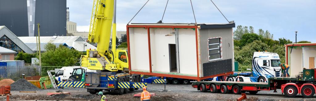 Image of school module being craned into place