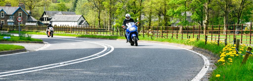 Motorbike riding round a bend in Patterdale