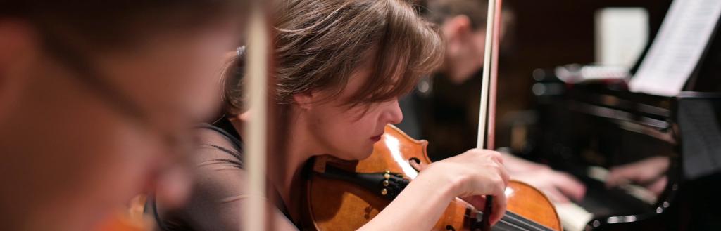 young people playing violins