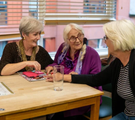 Three carers talking at a table